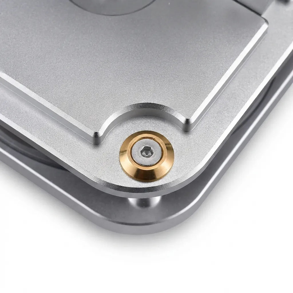Macro detail shot of the 6061 aluminum base plate and mounting screws of the Stirling engine